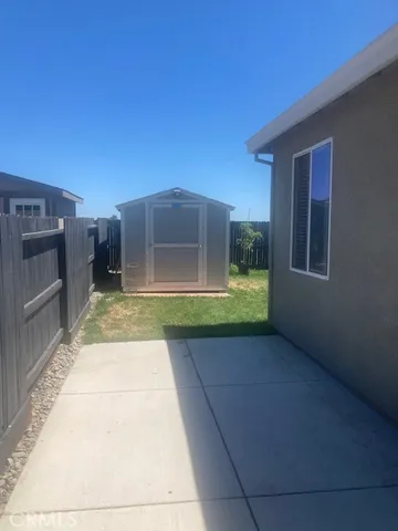 a living room with furniture a desk and chair with wooden floor
