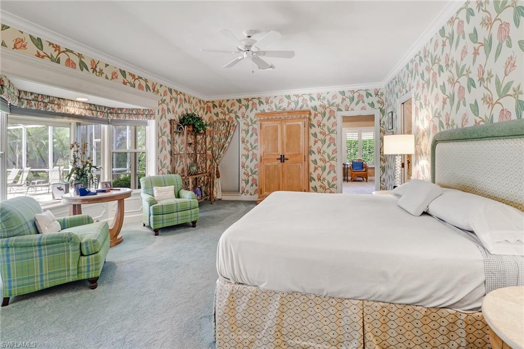 4556 Silver Fox Drive Naples, FL 34119 - Photo 12 of 22 a spacious bedroom with a bed a couch and a large window