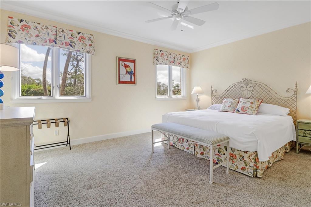 4556 Silver Fox Drive Naples, FL 34119 - Photo 13 of 22 a spacious bedroom with a bed and a window