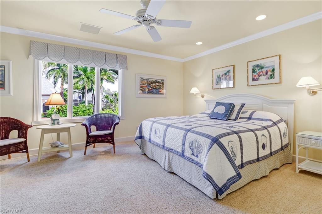 4556 Silver Fox Drive Naples, FL 34119 - Photo 14 of 22 a bedroom with a bed and a lounge chair