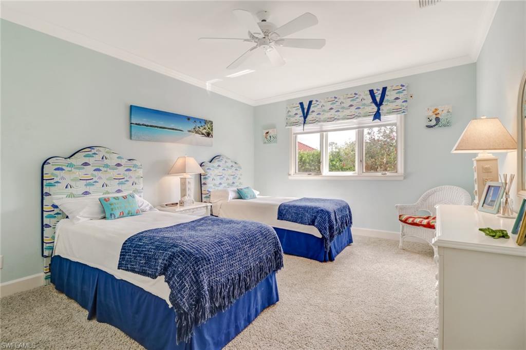 4556 Silver Fox Drive Naples, FL 34119 - Photo 16 of 22 a bedroom with a bed and window