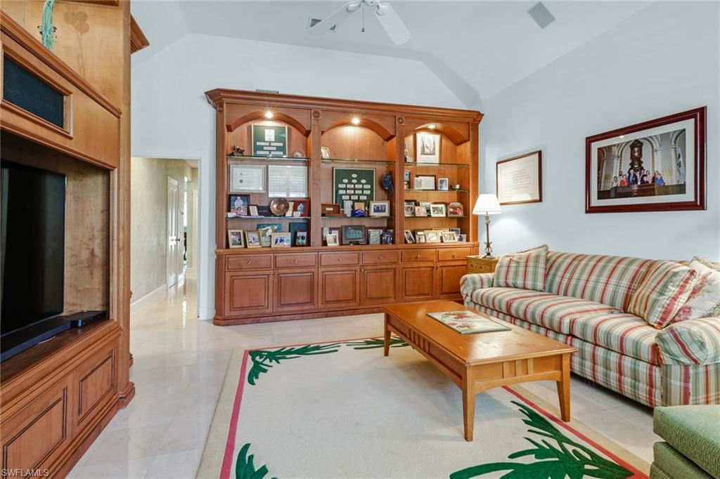 4556 Silver Fox Drive Naples, FL 34119 - Photo 17 of 22 a living room with furniture and a flat screen tv