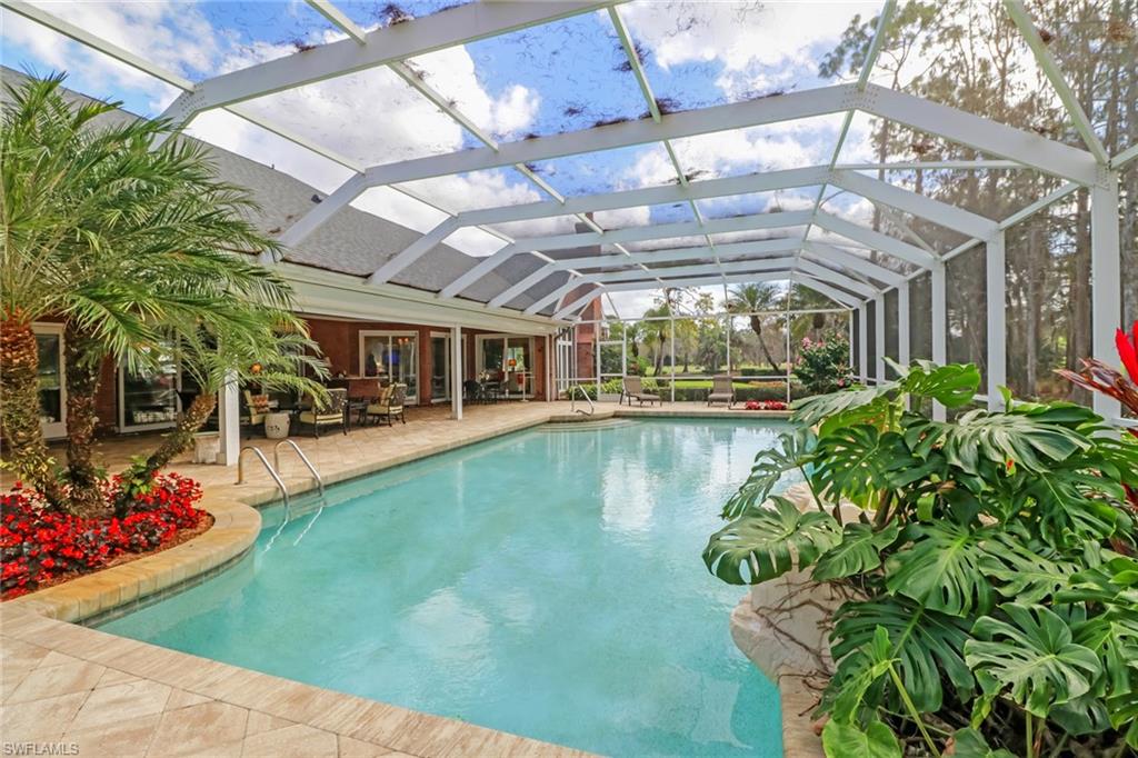 4556 Silver Fox Drive Naples, FL 34119 - Photo 19 of 22 a view of a swimming pool with a patio
