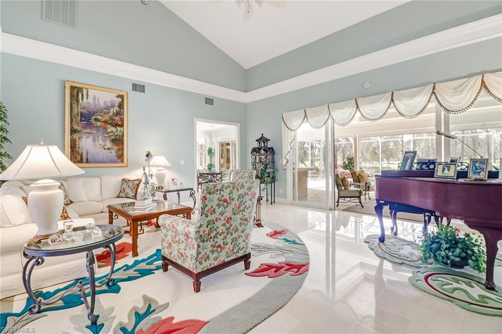 4556 Silver Fox Drive Naples, FL 34119 - Photo 8 of 22 a living room with furniture and a large window
