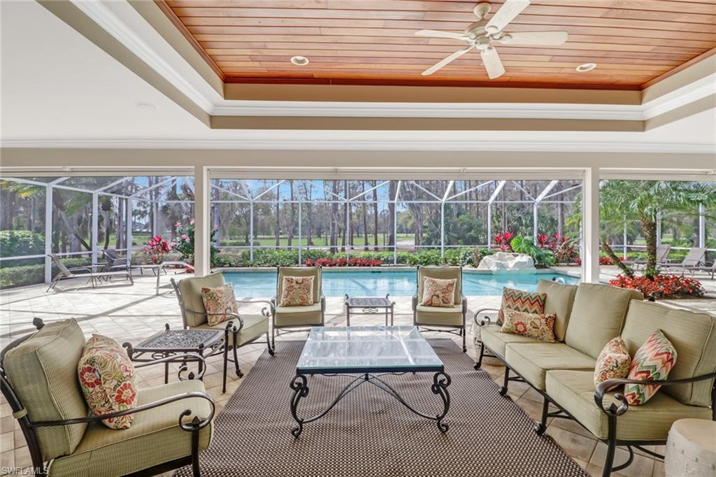 4556 Silver Fox Drive Naples, FL 34119 - Photo 10 of 22 a living room with furniture and a floor to ceiling window