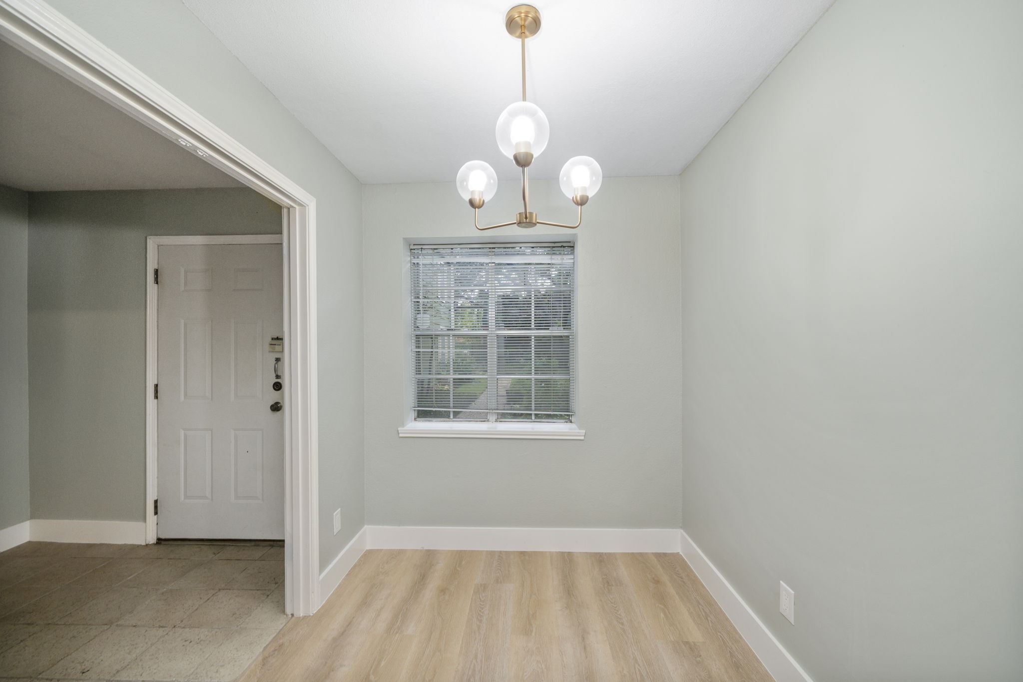 11550 Chimney Rock Road, Unit 521 Houston, TX 77035 - Photo 5 of 30 a view of an empty room with wooden floor and a window