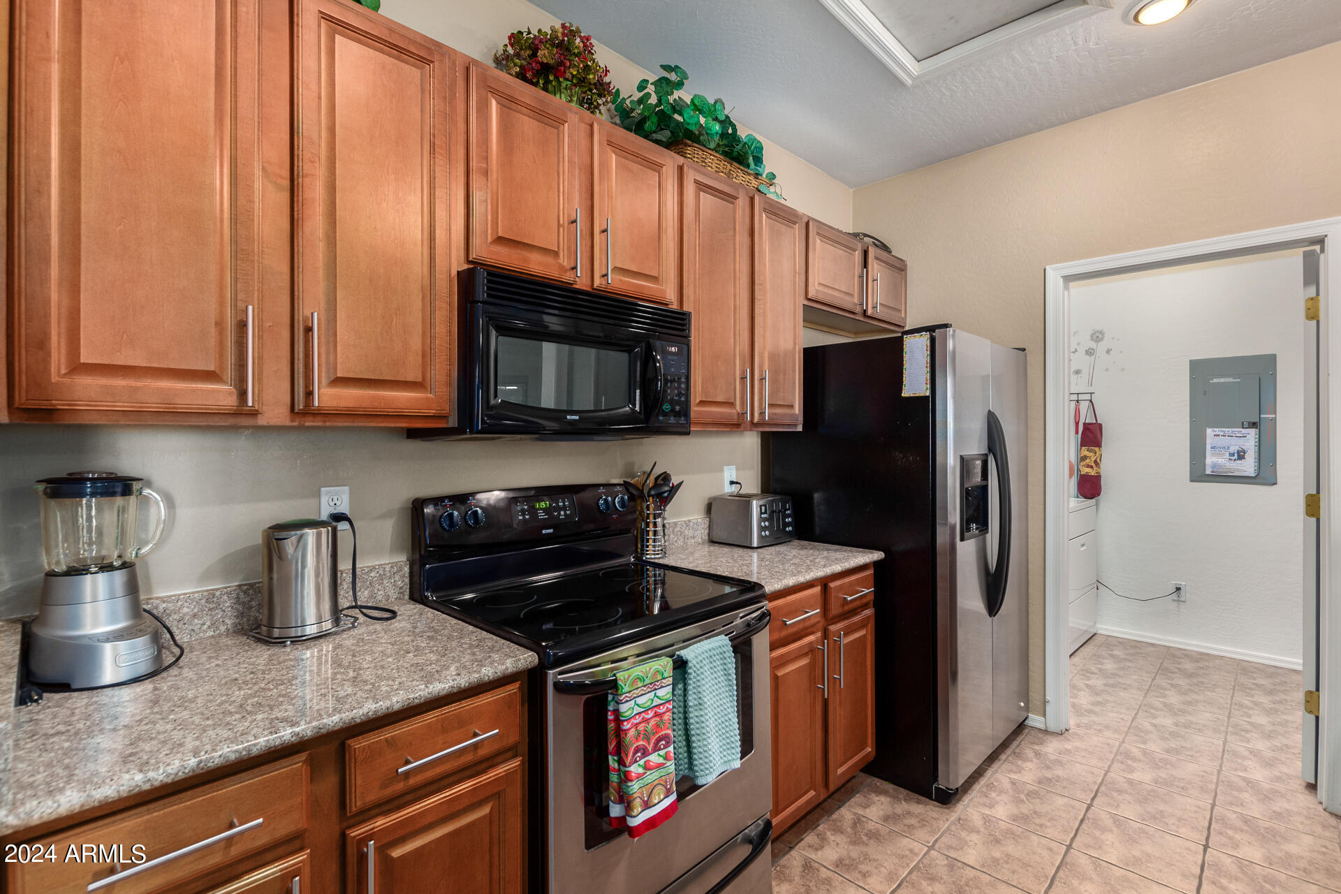 955 East Knox Road, Unit 244 Chandler, AZ 85225 - Photo 12 of 47 a kitchen with stainless steel appliances granite countertop a refrigerator a stove a sink and dishwasher