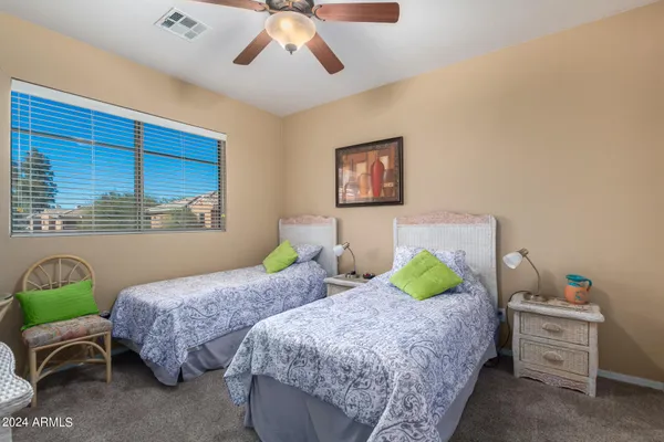 a bedroom with a bed and a mirror