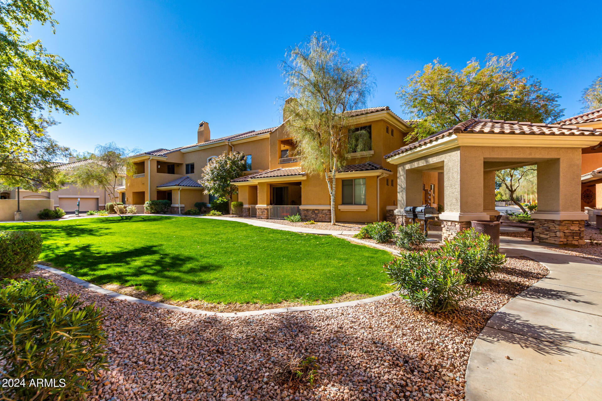 955 East Knox Road, Unit 244 Chandler, AZ 85225 - Photo 32 of 47 a front view of a house with a garden and yard