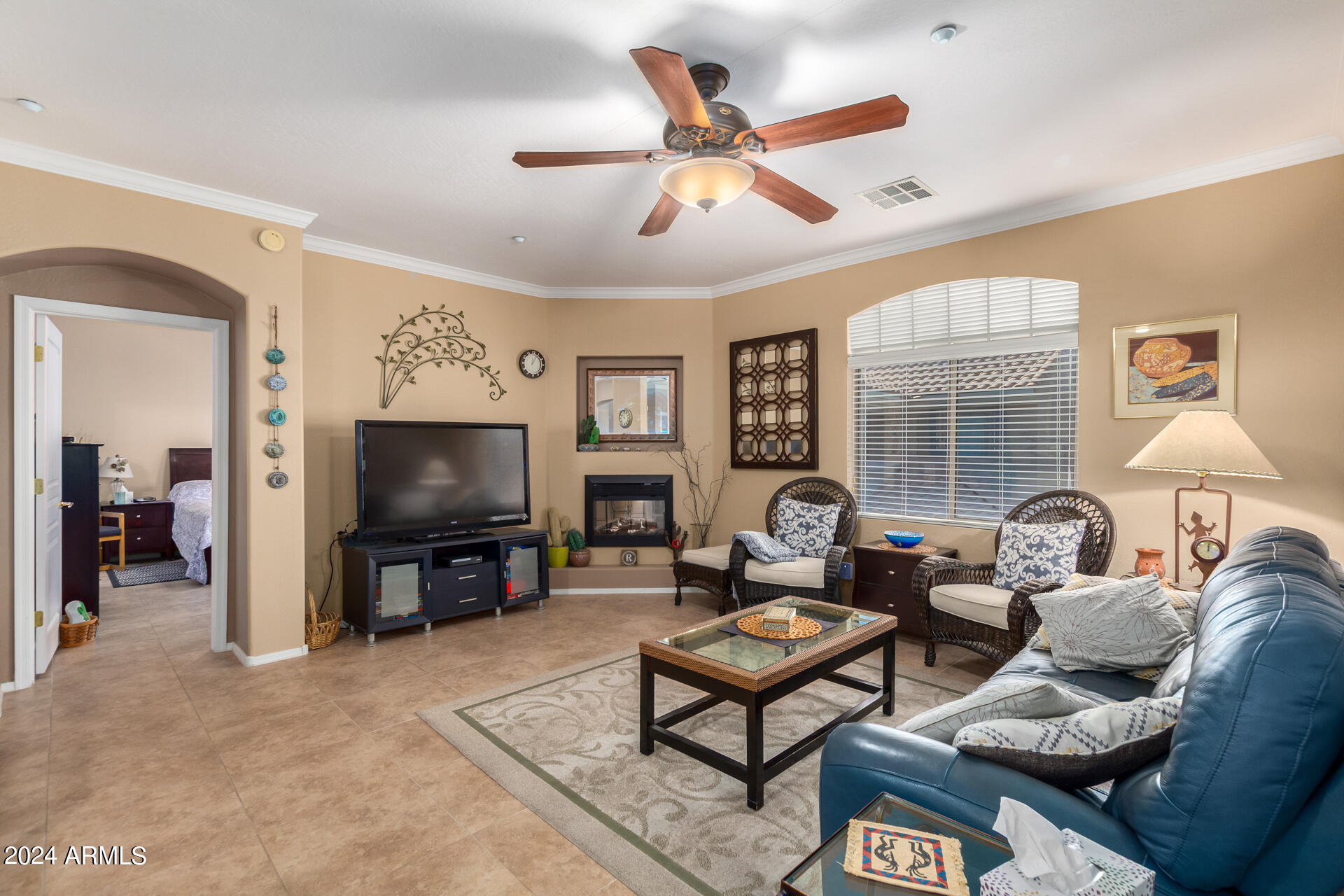 955 East Knox Road, Unit 244 Chandler, AZ 85225 - Photo 4 of 47 a living room with furniture a ceiling fan and a flat screen tv
