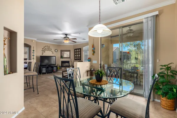 a view of a dining room with furniture a chandelier and wooden floor