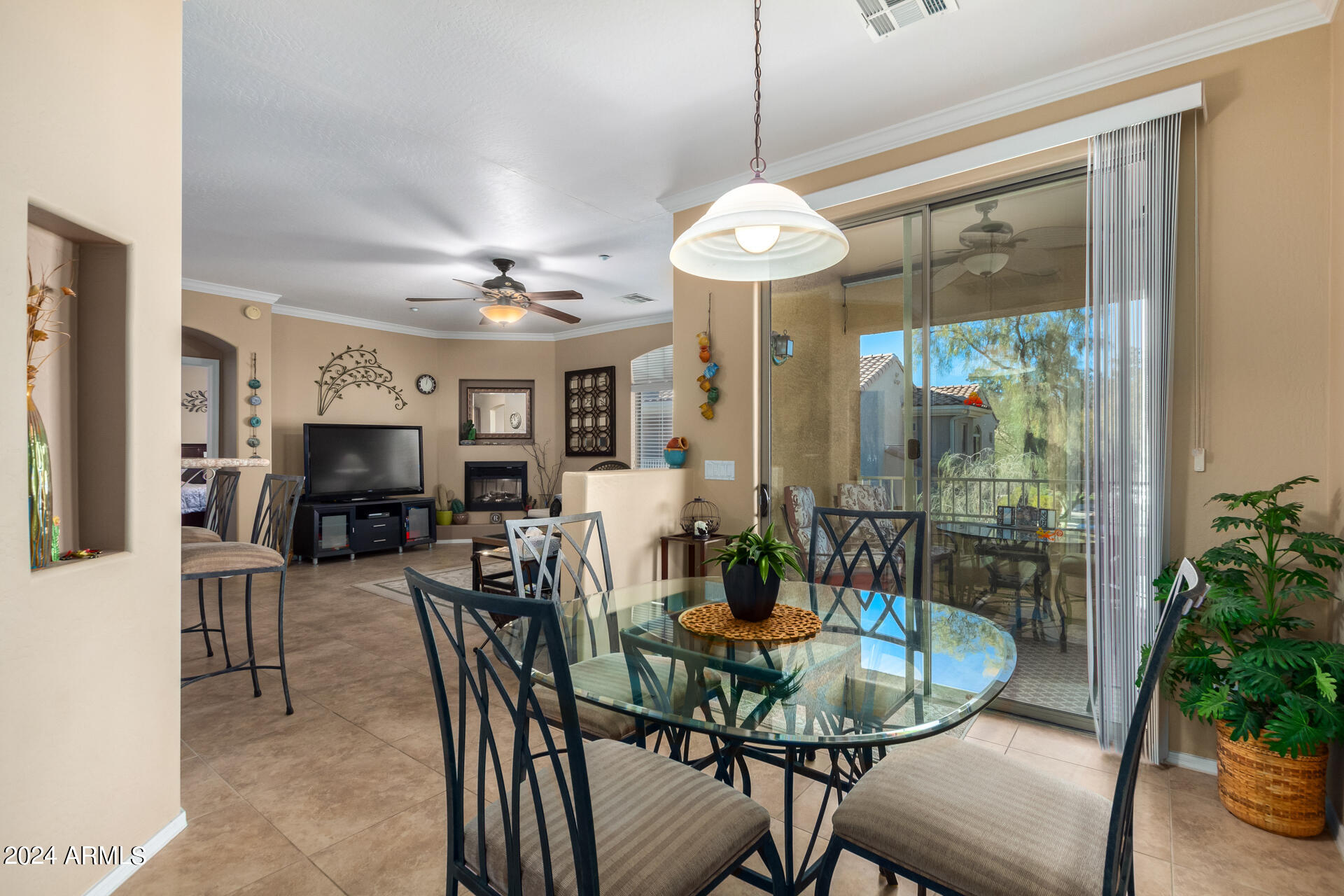 955 East Knox Road, Unit 244 Chandler, AZ 85225 - Photo 9 of 47 a view of a dining room with furniture wooden floor and chandelier