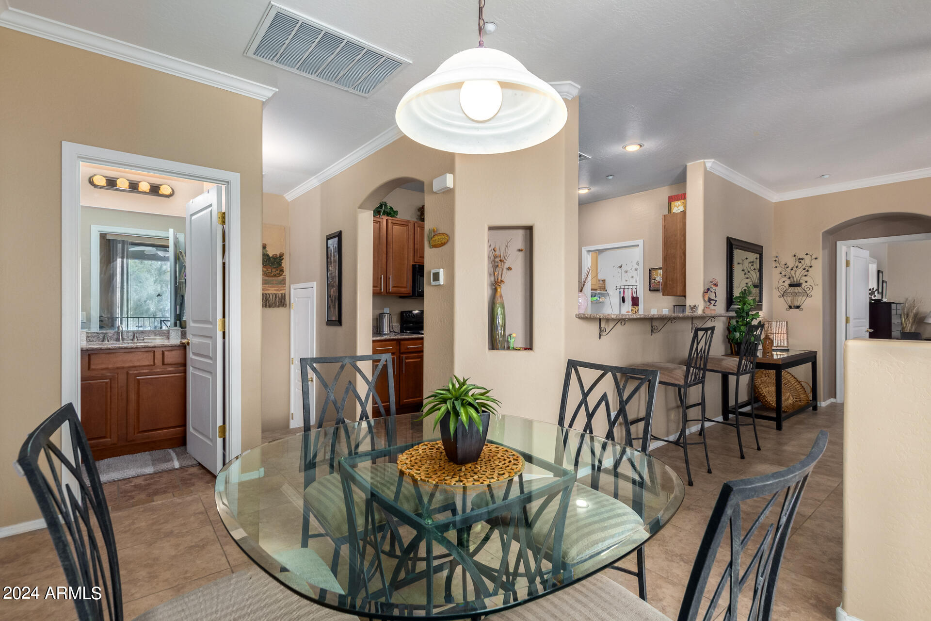 955 East Knox Road, Unit 244 Chandler, AZ 85225 - Photo 10 of 47 a view of a dining room with furniture a chandelier and wooden floor