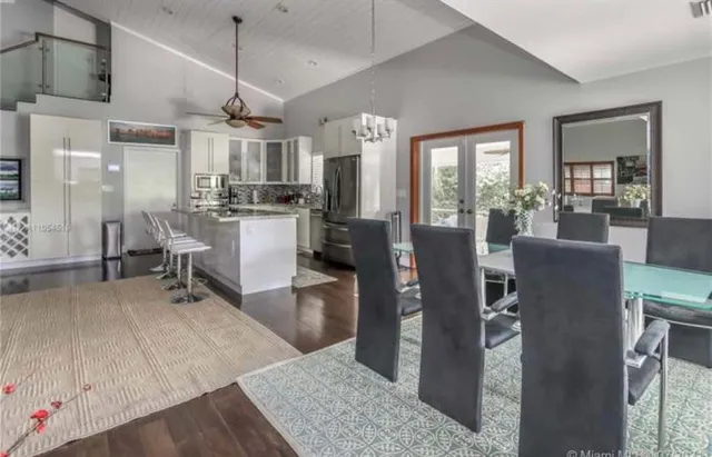 a room with lots of wooden furniture and windows