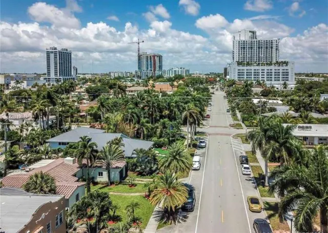 a room with stainless steel appliances kitchen island granite countertop furniture and a view of kitchen