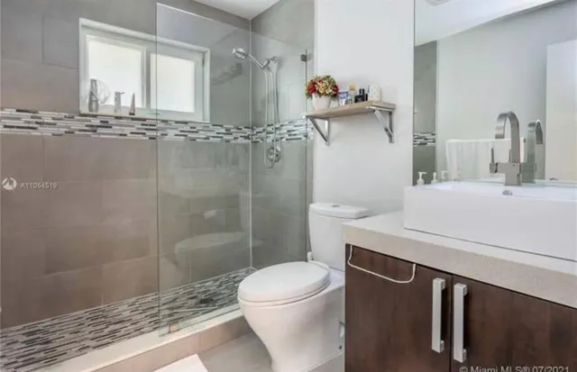 a spacious bathroom with a tub sink shower and mirror