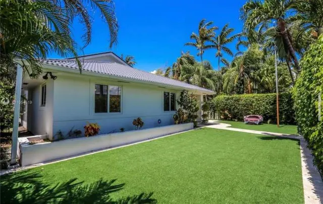 a swimming pool with outdoor seating and yard