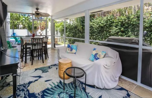 a backyard of a house with table and chairs