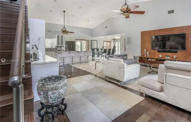 a living room with furniture and a flat screen tv
