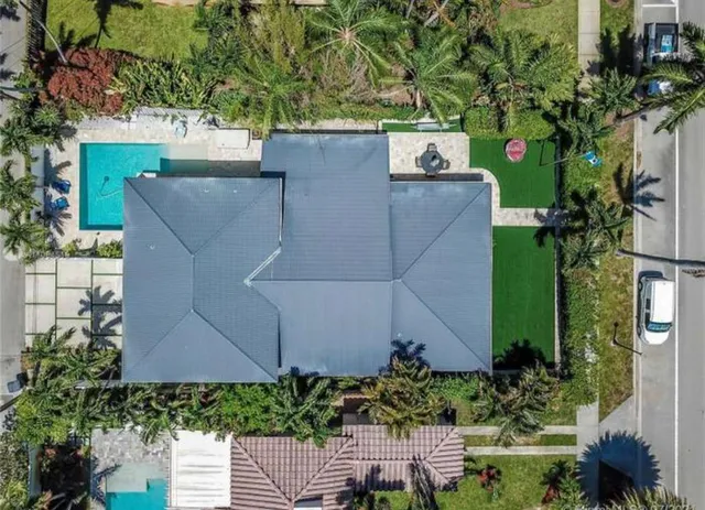 an aerial view of a house with a yard
