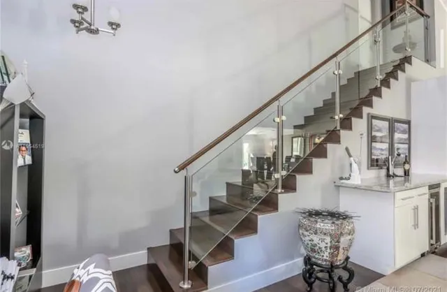 a view of entryway with wooden floor and stairs