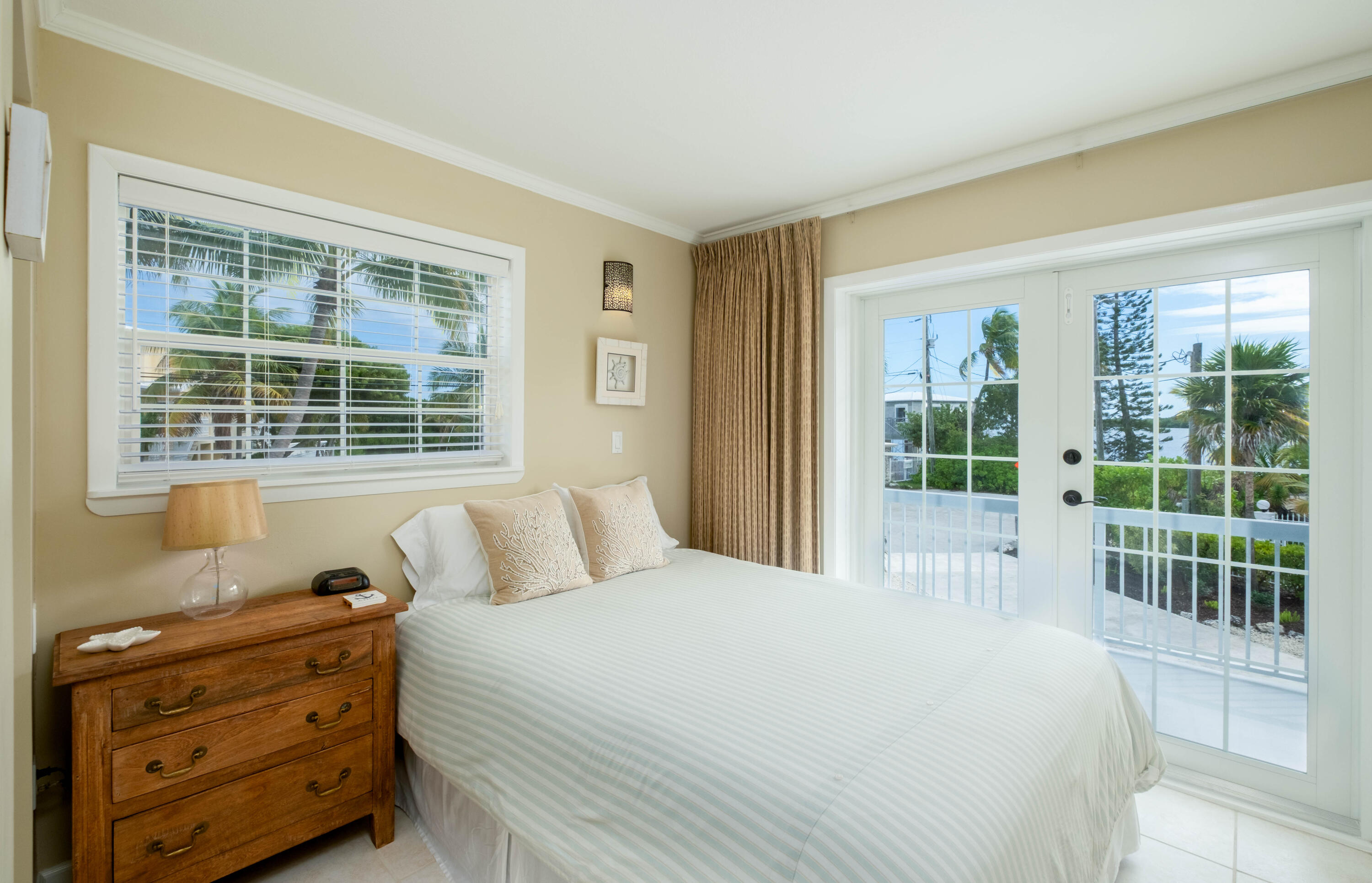 1202 Mockingbird Road Key Largo, FL 33037 - Photo 16 of 38 a bedroom with a bed and a window