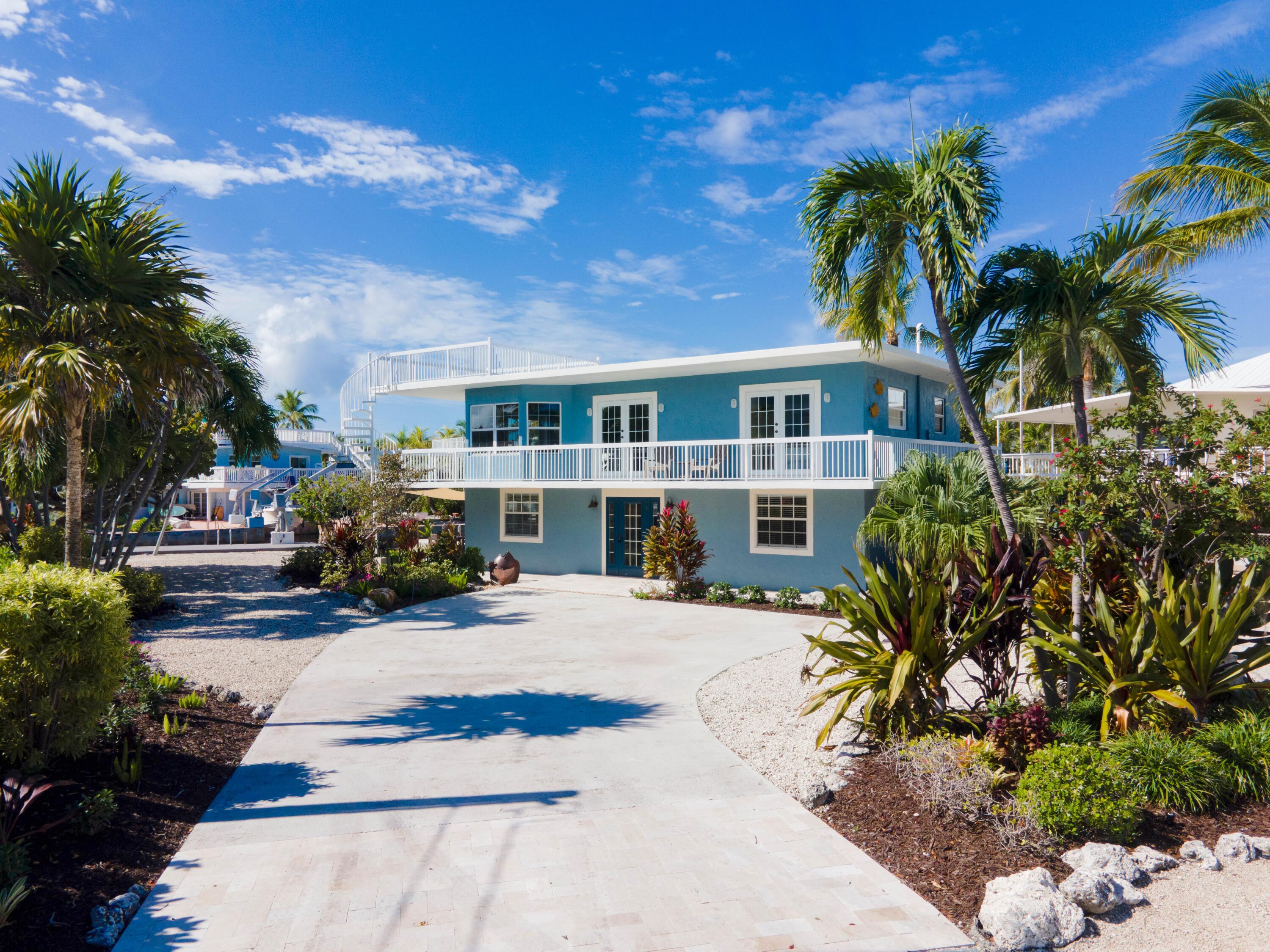 1202 Mockingbird Road Key Largo, FL 33037 - Photo 3 of 38 a view of a house with a patio