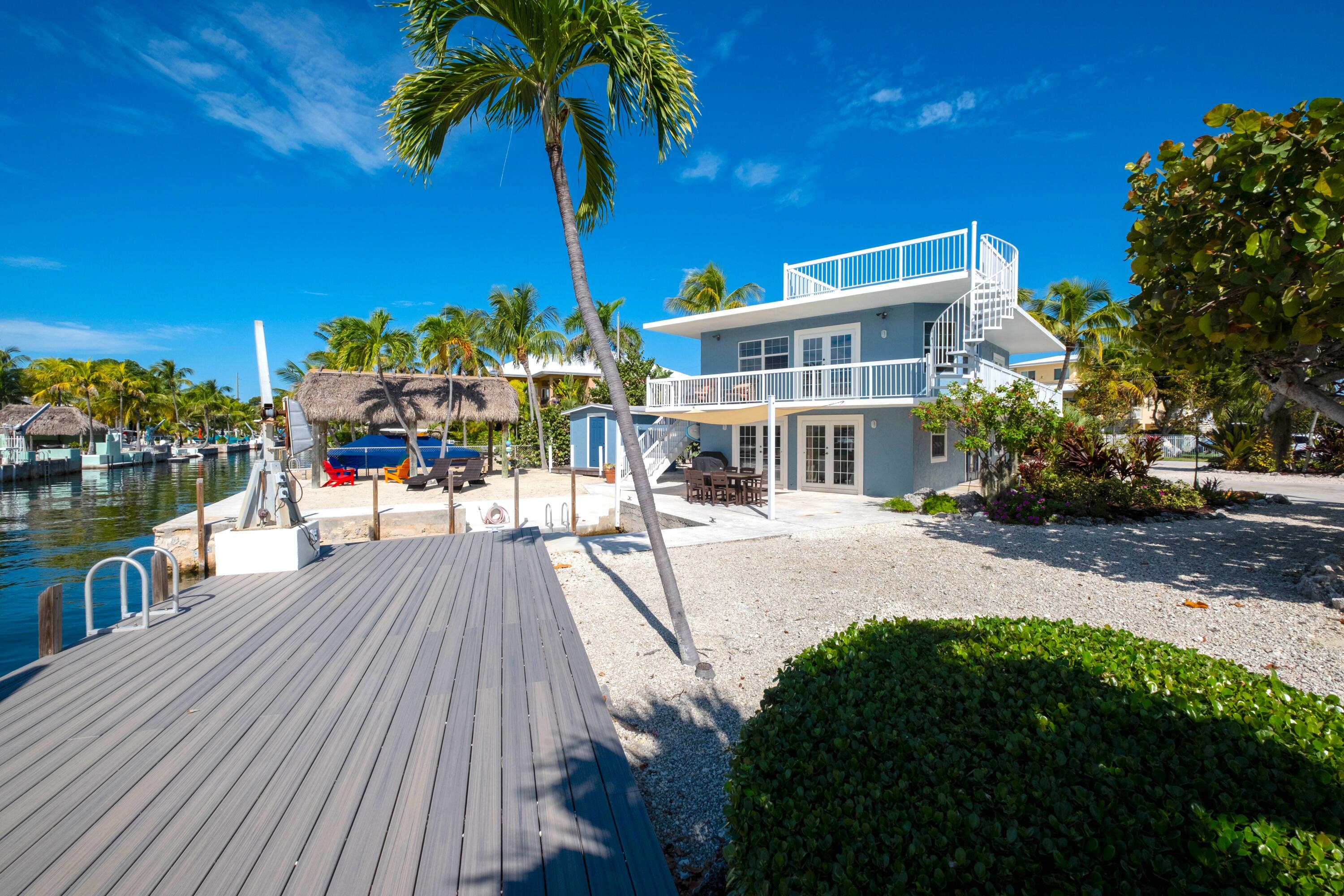 1202 Mockingbird Road Key Largo, FL 33037 - Photo 33 of 38 a view of a house with a patio