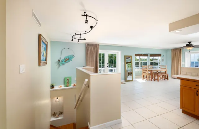 a living room with furniture kitchen view and a window