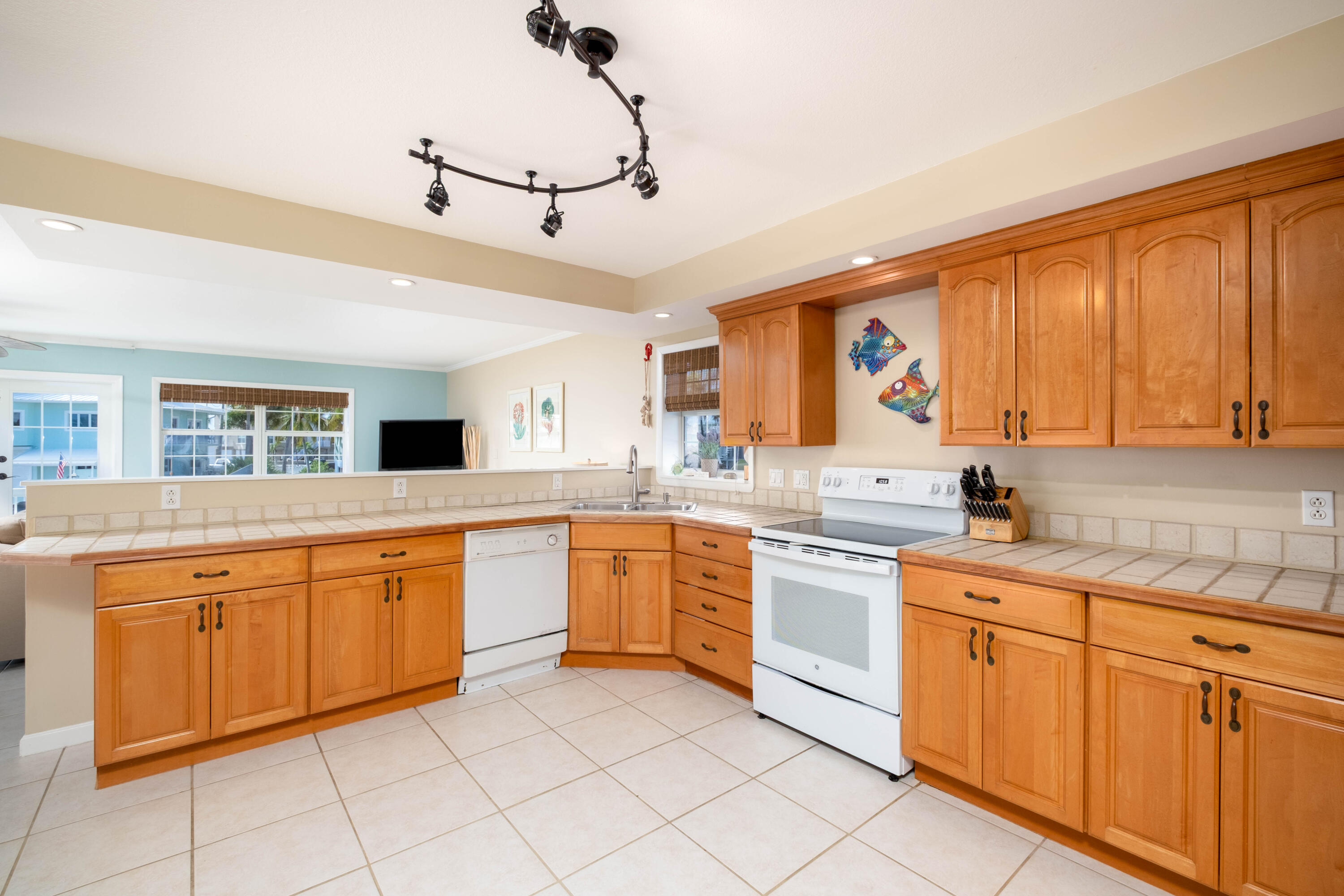 1202 Mockingbird Road Key Largo, FL 33037 - Photo 8 of 38 a kitchen with granite countertop cabinets stainless steel appliances a sink and a window