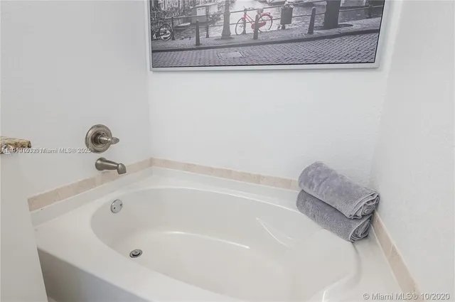 a white bath tub sitting next to a sink