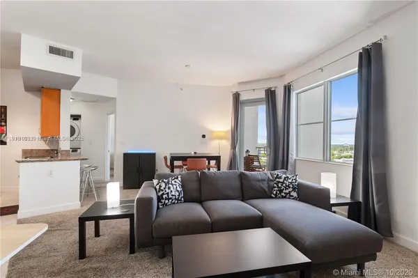 a living room with furniture and a window