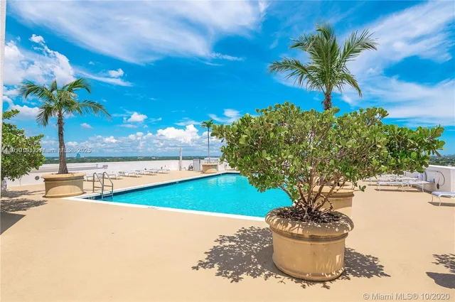 a view of a backyard of the house with a patio