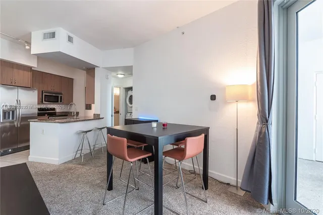 a kitchen with a sink cabinets and refrigerator