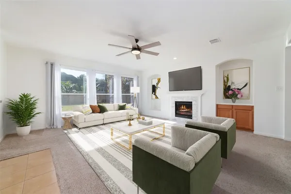 a living room with furniture a fireplace and a flat screen tv