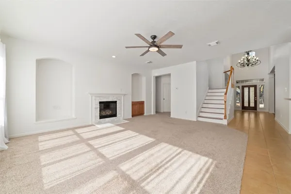 a view of a livingroom with wooden floor and a ceiling fan