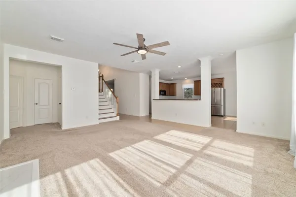 a view of a big room with closet and a ceiling fan
