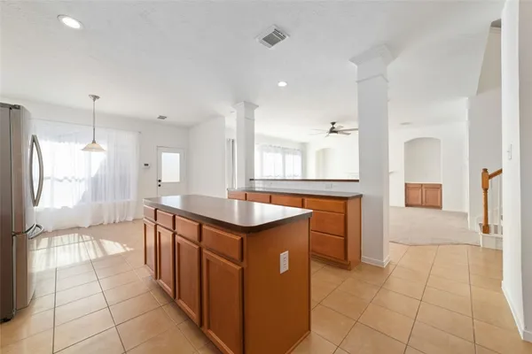 a kitchen with stainless steel appliances granite countertop a sink and a refrigerator