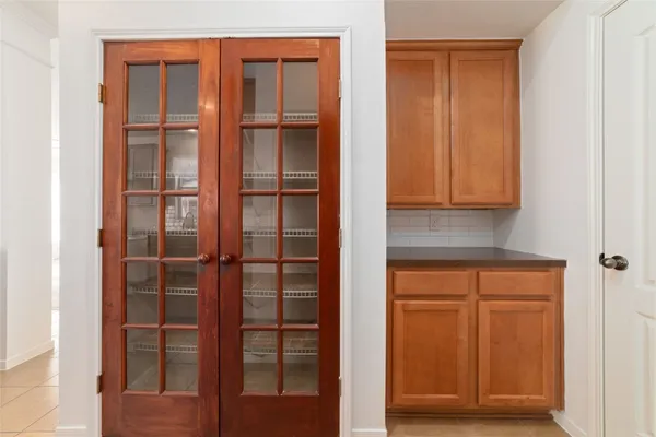 a view of kitchen with wooden floor and cabinets