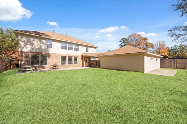 a front view of a house with a yard and green space