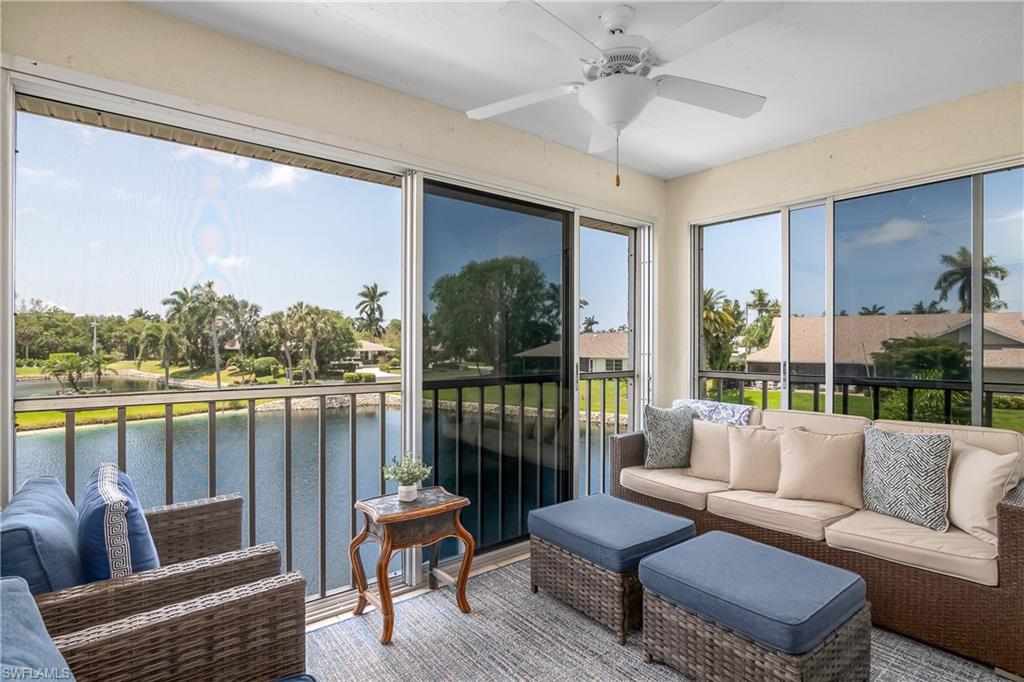 105 Georgetown Boulevard, Unit 105 Naples, FL 34112 - Photo 1 of 28 a living room with furniture and a large window