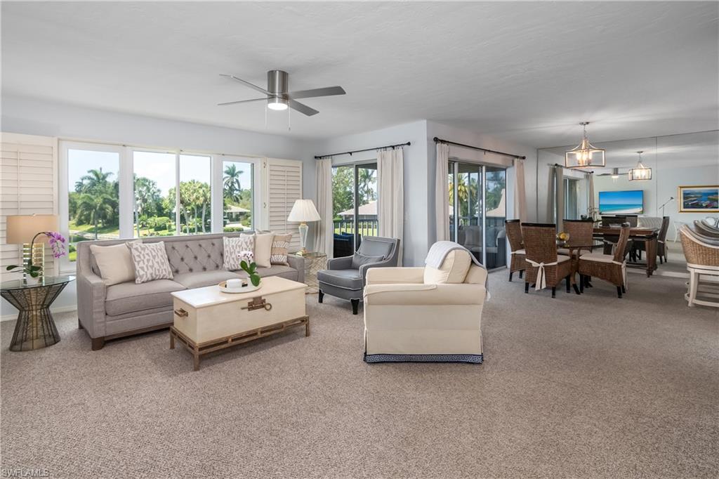 105 Georgetown Boulevard, Unit 105 Naples, FL 34112 - Photo 11 of 28 a living room with furniture and a large window