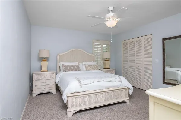 a bedroom with a bed and flat screen tv