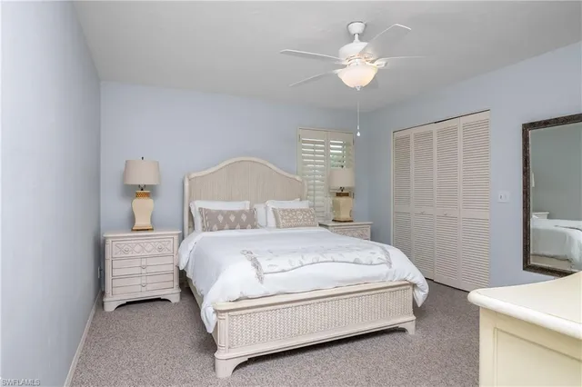 a bedroom with a bed and flat screen tv