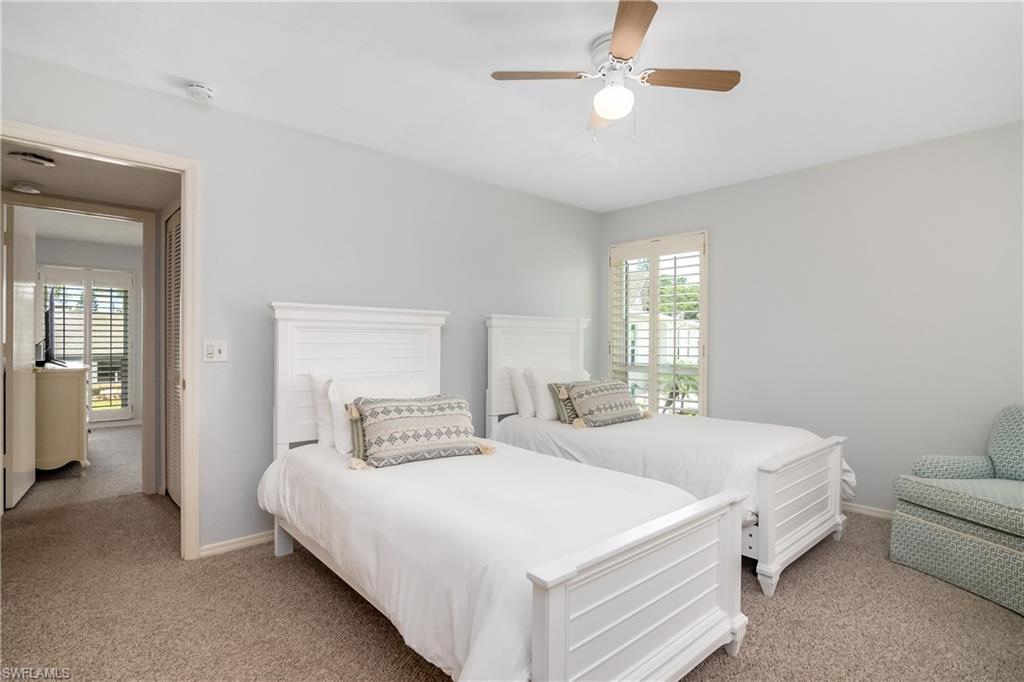 105 Georgetown Boulevard, Unit 105 Naples, FL 34112 - Photo 16 of 28 a bedroom with a bed couch and window
