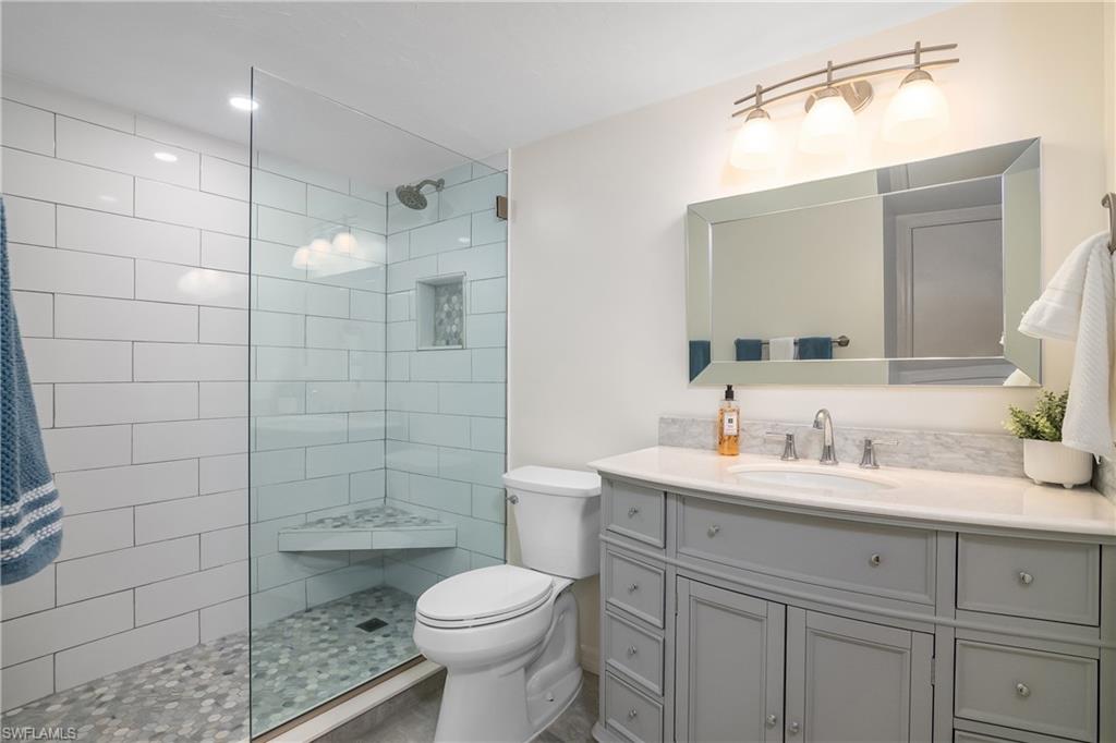 105 Georgetown Boulevard, Unit 105 Naples, FL 34112 - Photo 17 of 28 a bathroom with a sink a toilet and shower