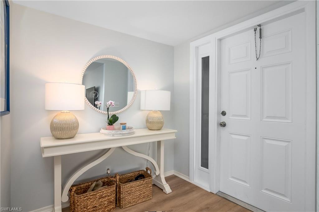 105 Georgetown Boulevard, Unit 105 Naples, FL 34112 - Photo 18 of 28 a workspace with furniture and mirror