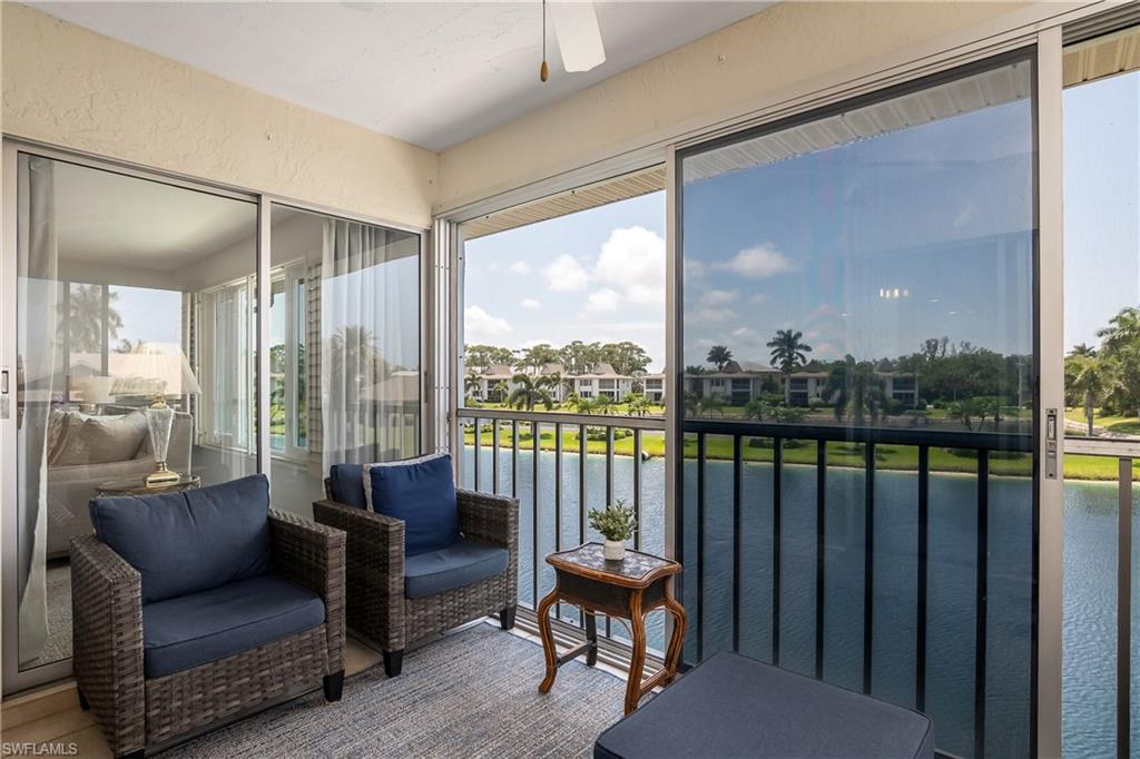 105 Georgetown Boulevard, Unit 105 Naples, FL 34112 - Photo 20 of 28 a balcony with furniture and a floor to ceiling window