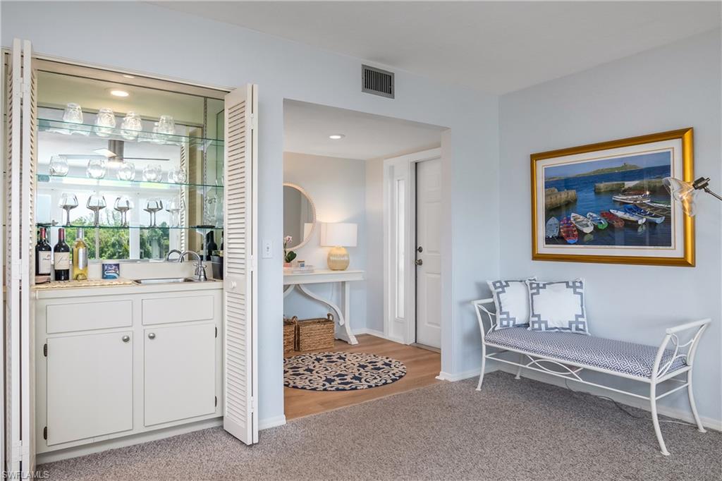 105 Georgetown Boulevard, Unit 105 Naples, FL 34112 - Photo 21 of 28 a bedroom with furniture and a window