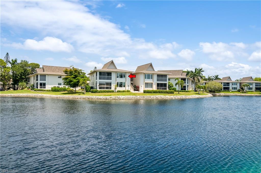 105 Georgetown Boulevard, Unit 105 Naples, FL 34112 - Photo 22 of 28 a view of pool next to a lake with houses
